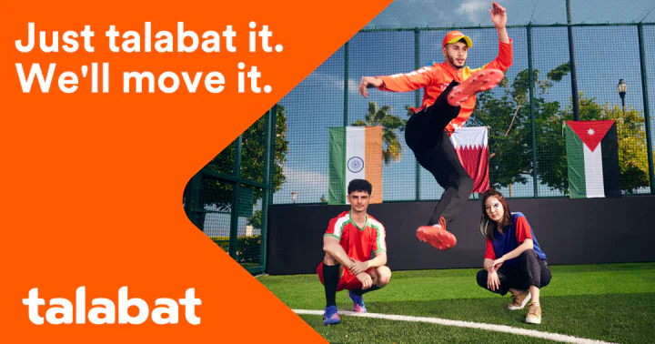 Key creative — a player in an orange top leaps above two crouching players, with three national flags hung on the fence behind them, beside the orange panel and the talabat logo